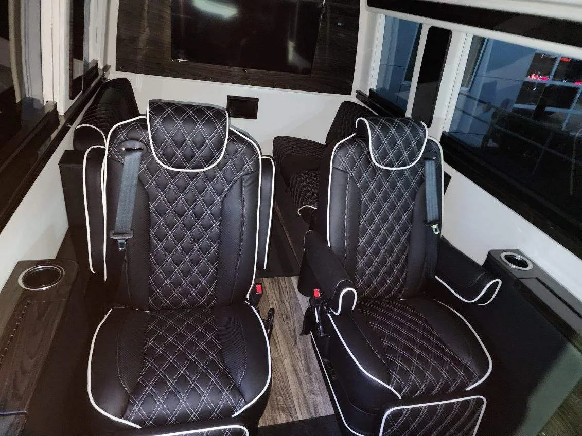 Mercedes-Benz Sprinter captain chairs and flat-screen TV in the executive cabin